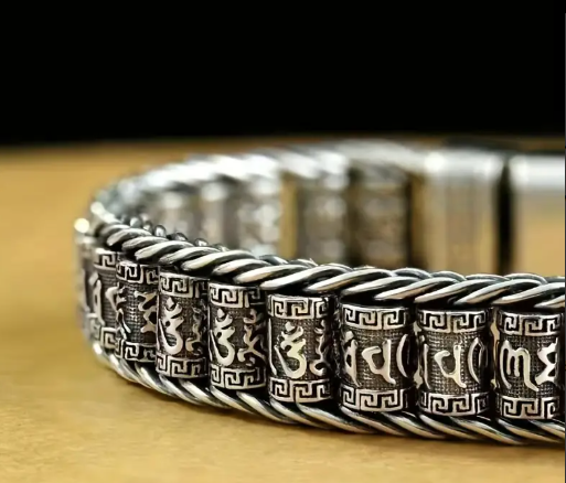 Close-up of PATHFINDER Bracelet’s clasp featuring six-character mantra and intricate metalwork