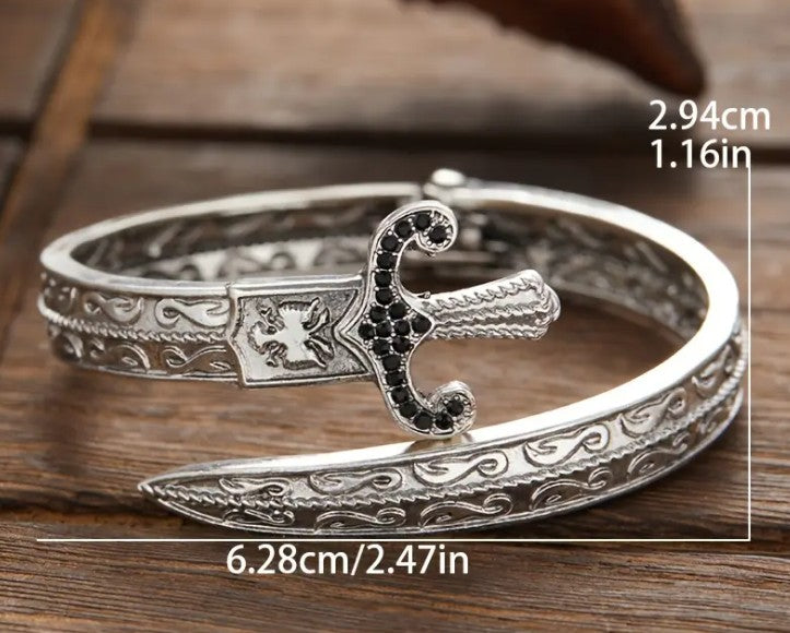 GLADIUS Bracelet displayed on hexagonal platform, highlighting intricate carving and bold statement style