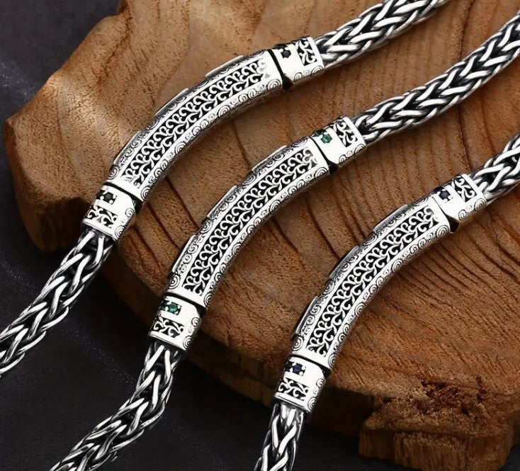 BRAZEN Bracelet featuring bold green zirconia stone set in braided silver chain with vintage-inspired texture