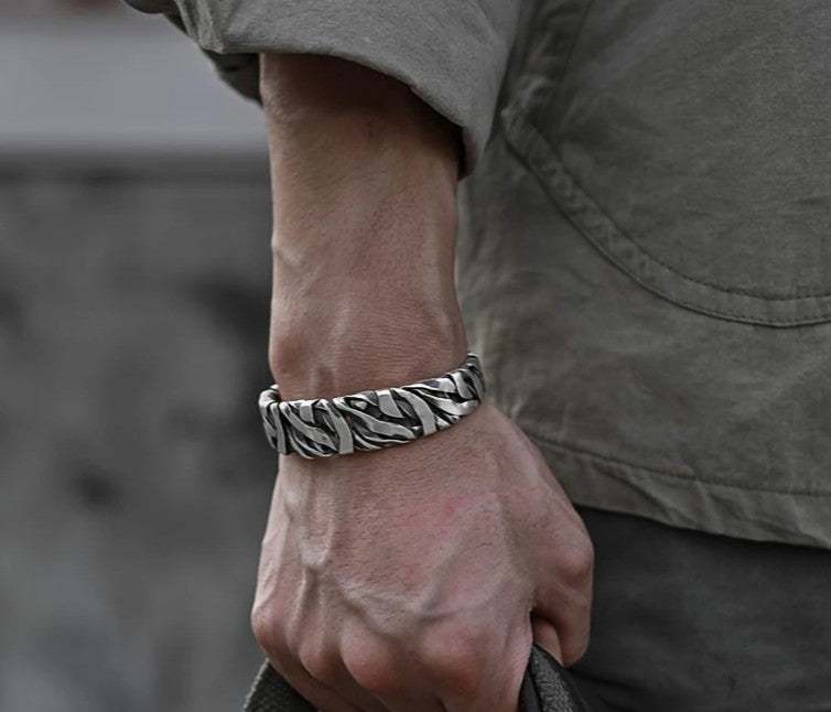 STRIKE Wide Cuff Bracelet worn on wrist, showcasing bold striped texture and vintage silver finish