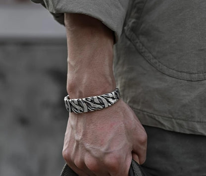 STRIKE Wide Cuff Bracelet worn on wrist, showcasing bold striped texture and vintage silver finish