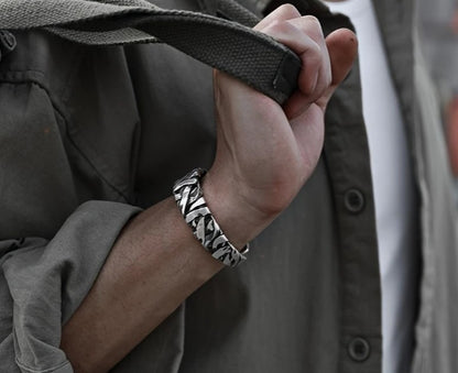 STRIKE Bracelet styled on wrist, emphasizing wide band and masculine vintage-inspired design