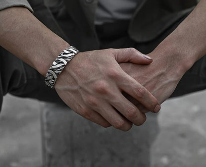 STRIKE Wide Cuff Bracelet displayed on black surface, highlighting textured silver finish and bold silhouette