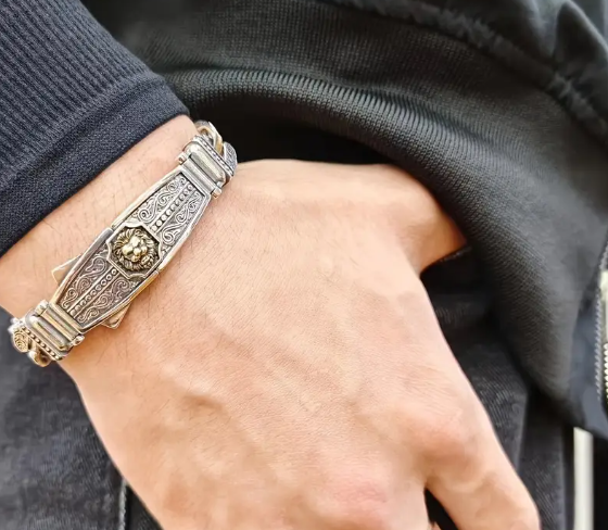 Close-up of NEMEAN Bracelet’s lion head centerpiece, highlighting engraved textures and regal craftsmanship