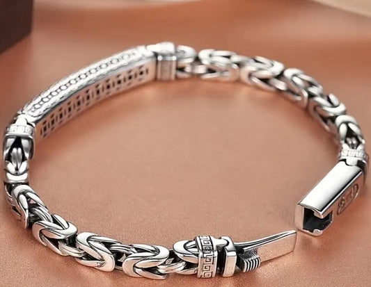 Close-up of KIEL Bracelet’s barrel clasp featuring peace pattern engraving and polished silver finish