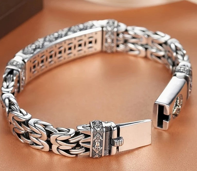 WISDOM Bracelet arranged in circular layout showcasing woven chain texture and crest centerpiece