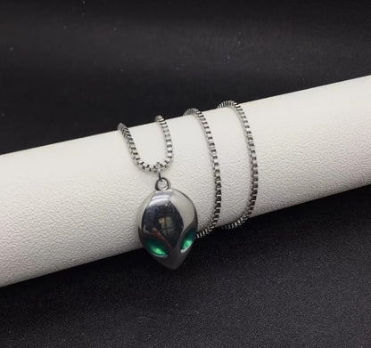 Pair of SPOCK Alien Pendant Necklaces featuring metallic alien head pendants with green eyes and silver chains, styled for bold streetwear looks