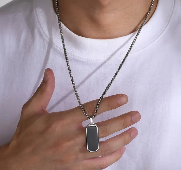 Man wearing VEGAS Black Enamel Pendant Necklace and matching ring, styled for a confident, minimalist look