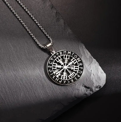 Detailed close-up of VEGVISIR Viking medallion pendant, featuring compass symbol and runic inscriptions in polished silver tone